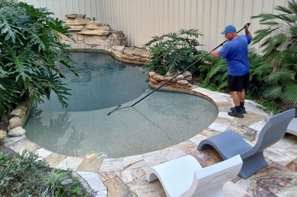 Picture of someone cleaning a pool.